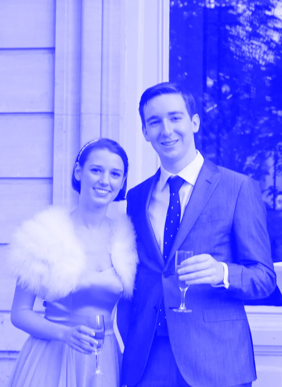 Jess & Patrick at his sister's wedding in Paris dressed in a ball gown with a fur collar and a suit.